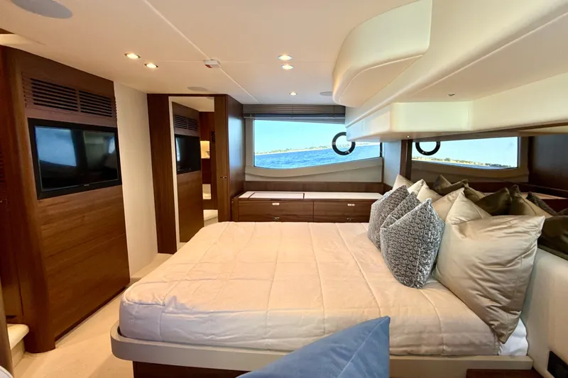  Yacht Photos Pics Luxurious bedroom interior of 2026 Princess F50 yacht with ocean view and elegant decor.