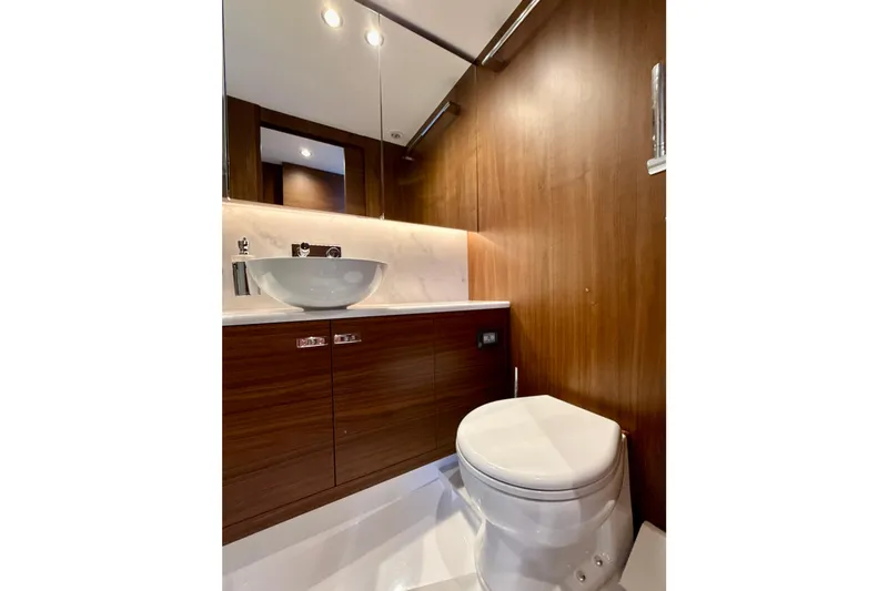  Yacht Photos Pics Luxurious bathroom in 2026 Princess F50 yacht with modern fixtures and wooden cabinetry.