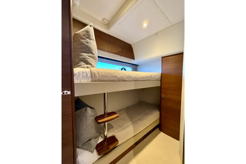  Yacht Photos Pics Bunk beds in 2026 Princess F50 yacht cabin with wooden accents and window view.