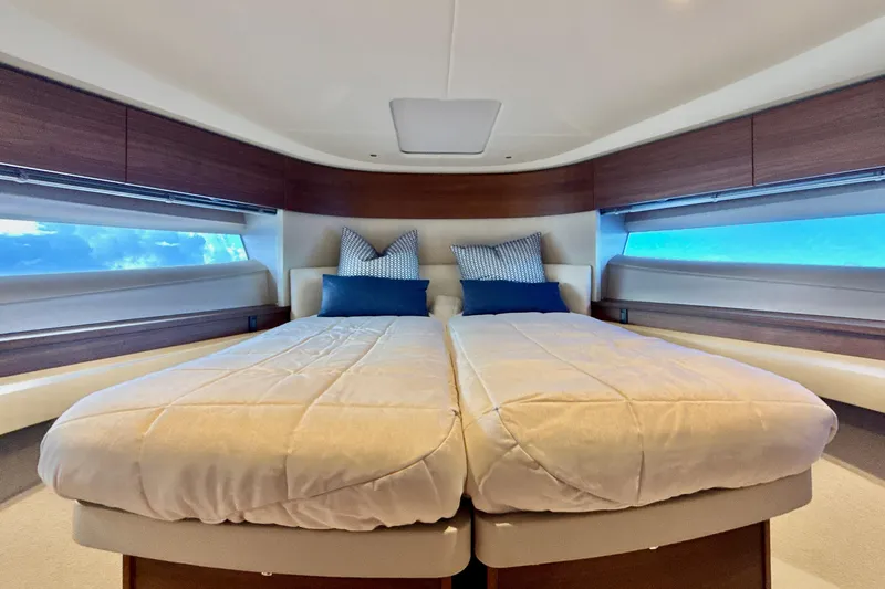  Yacht Photos Pics Luxurious interior of 2026 Princess F50 yacht with elegant bedding and panoramic windows.