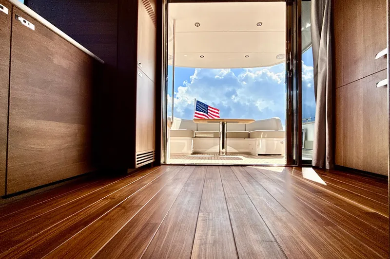  Yacht Photos Pics Luxurious interior of 2026 Princess F50 yacht with American flag and wooden flooring.
