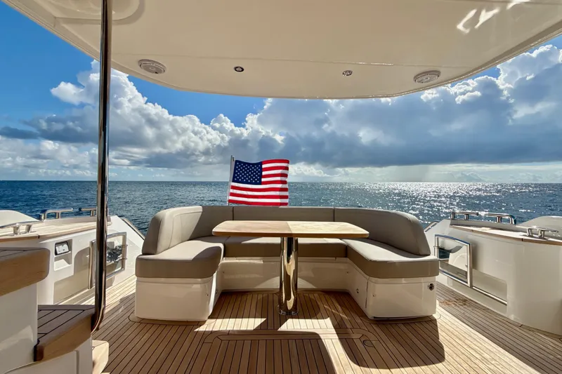  Yacht Photos Pics Luxurious 2026 Princess F50 yacht deck with seating, table, and ocean view.