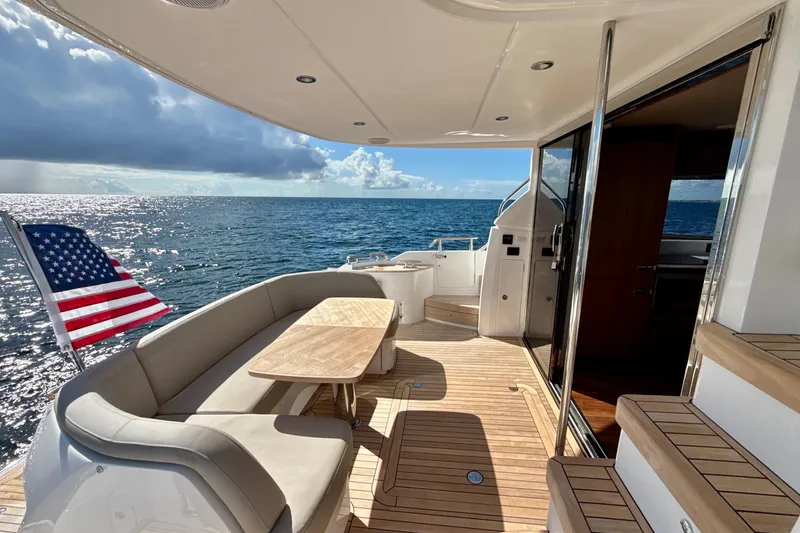  Yacht Photos Pics Luxurious 2026 Princess F50 yacht deck with ocean view and American flag.