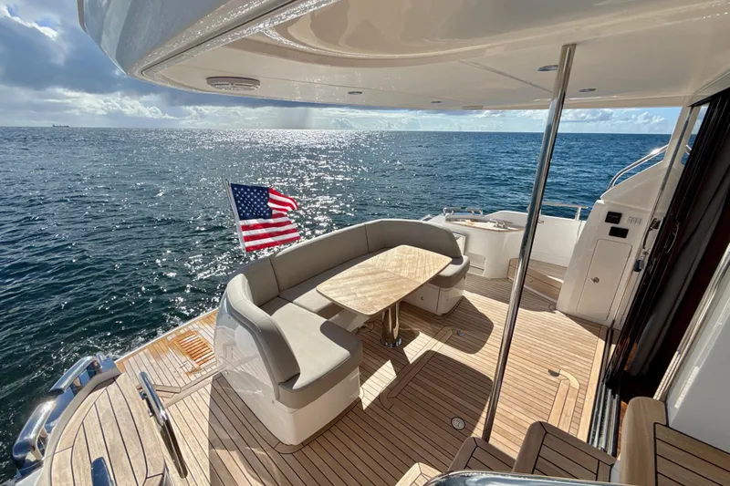  Yacht Photos Pics Luxurious 2026 Princess F50 yacht deck with seating, ocean view, and American flag.