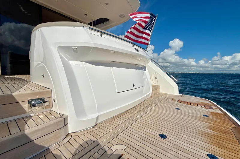  Yacht Photos Pics Luxury 2026 Princess F50 yacht with American flag, wooden deck, and ocean view.