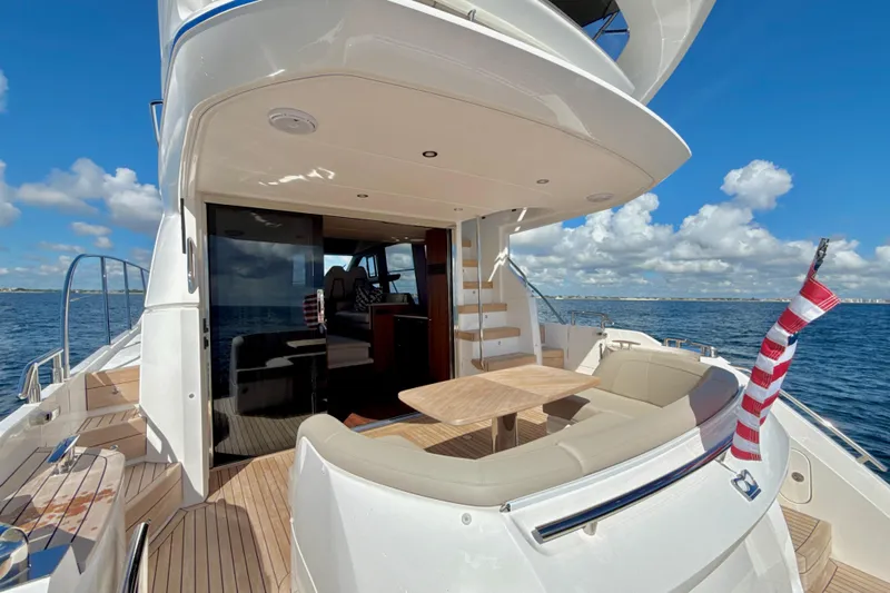  Yacht Photos Pics Luxurious 2026 Princess F50 yacht deck with seating, table, and ocean view.
