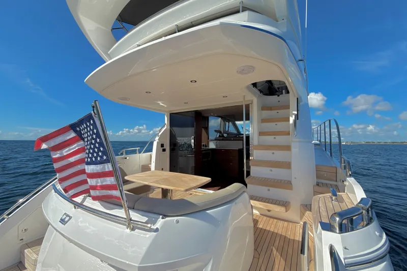  Yacht Photos Pics Luxurious 2026 Princess F50 yacht with American flag, elegant deck, and ocean view.