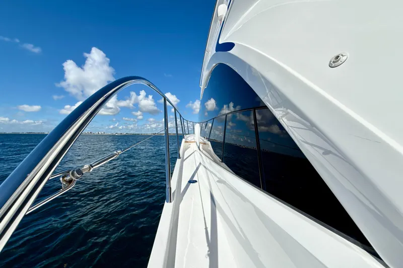  Yacht Photos Pics Sleek 2026 Princess F50 yacht cruising on open water under clear blue skies.