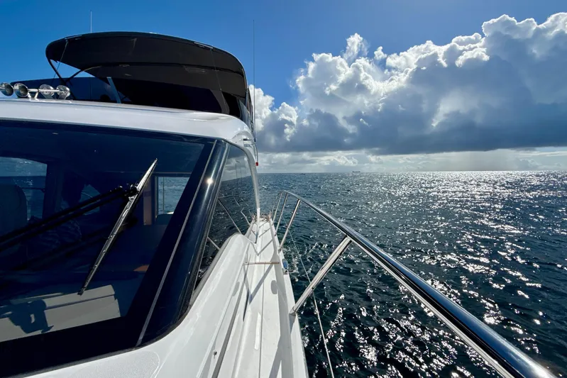  Yacht Photos Pics 2026 Princess F50 yacht cruising on open sea under a bright blue sky.