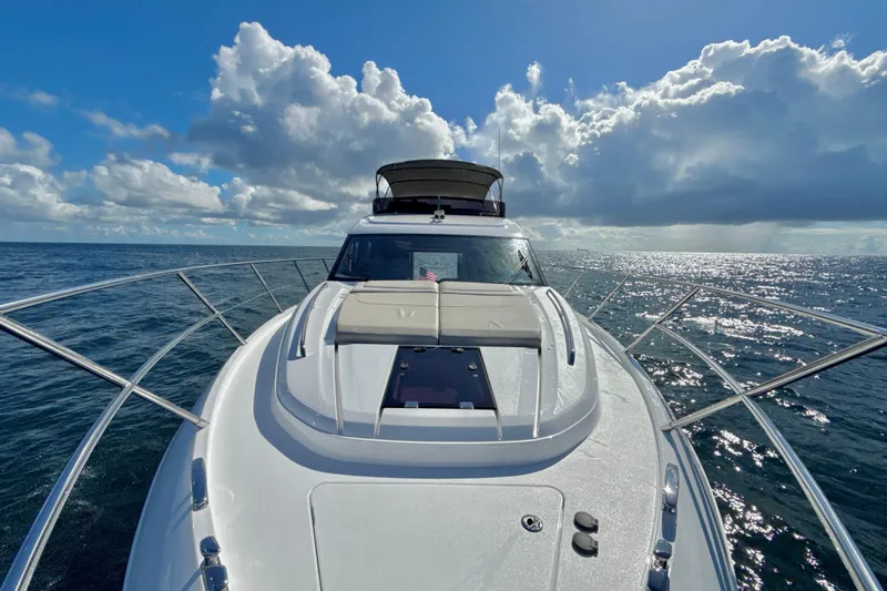  Yacht Photos Pics Luxurious 2026 Princess F50 yacht cruising on open sea under a bright, cloudy sky.