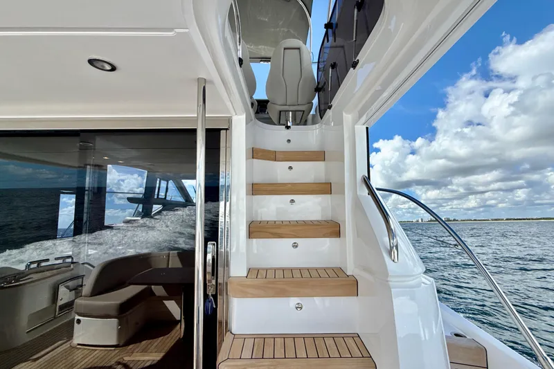  Yacht Photos Pics Luxury Princess F50 yacht interior with wooden stairs, ocean view, and modern design, 2026 model.