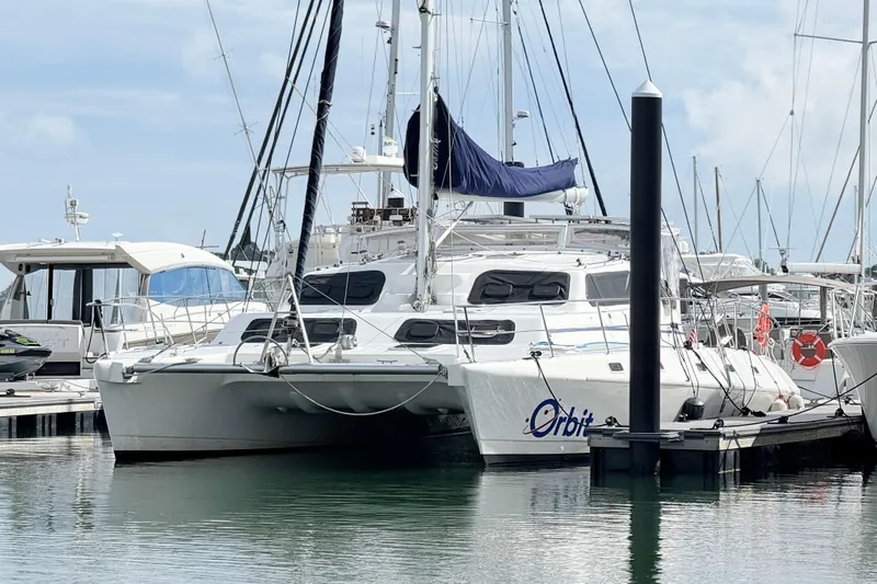 Orbit Yacht Photos Pics 2011 Royal Cape Catamarans Majestic 53 docked at marina, featuring sleek design and spacious deck.