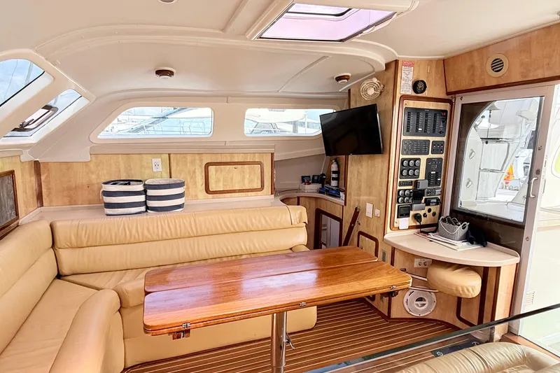 Orbit Yacht Photos Pics Luxurious interior of 2011 Royal Cape Catamarans Majestic 53 with leather seating and wooden accents.