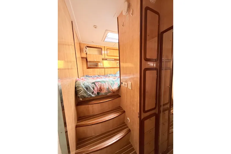 Orbit Yacht Photos Pics Luxurious interior of 2011 Royal Cape Catamarans Majestic 53 with wooden finishes and cozy bedding.