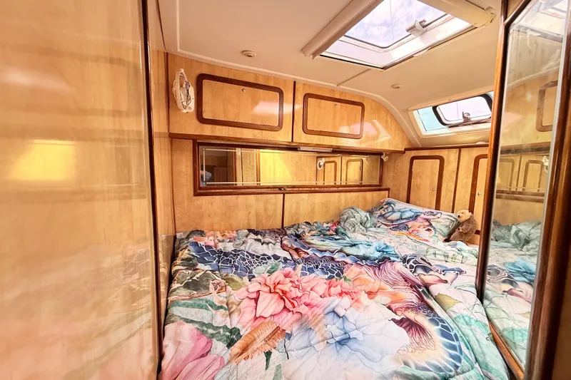 Orbit Yacht Photos Pics Luxurious cabin interior of 2011 Royal Cape Catamarans Majestic 53 with vibrant bedding.