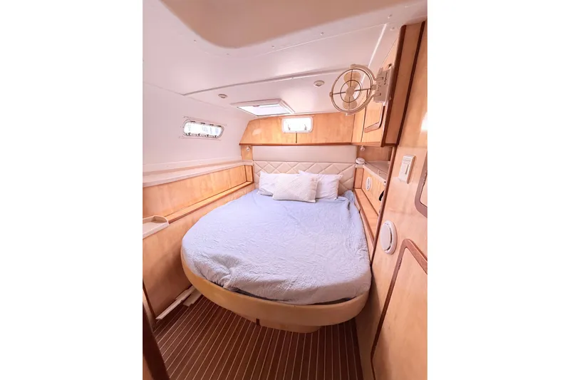 Orbit Yacht Photos Pics Luxurious cabin interior of 2011 Royal Cape Catamarans Majestic 53 with cozy bed and wooden finish.