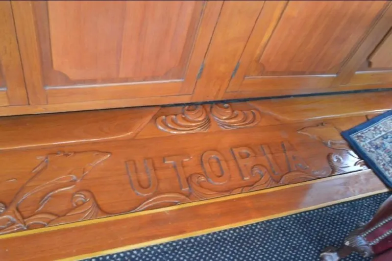 Top Coat Yacht Photos Pics Wooden interior detail of 1974 Pacemaker Cockpit Motoryacht with carved "UTOPIA" design.