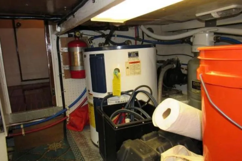 Top Coat Yacht Photos Pics Engine room of a 1974 Pacemaker Cockpit Motoryacht with equipment and storage items.