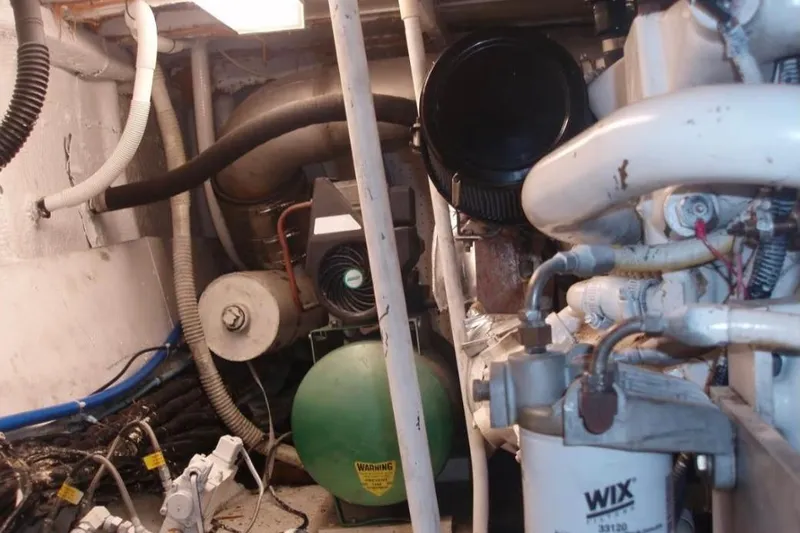 Top Coat Yacht Photos Pics Engine room of a 1974 Pacemaker Cockpit Motoryacht with visible machinery and components.