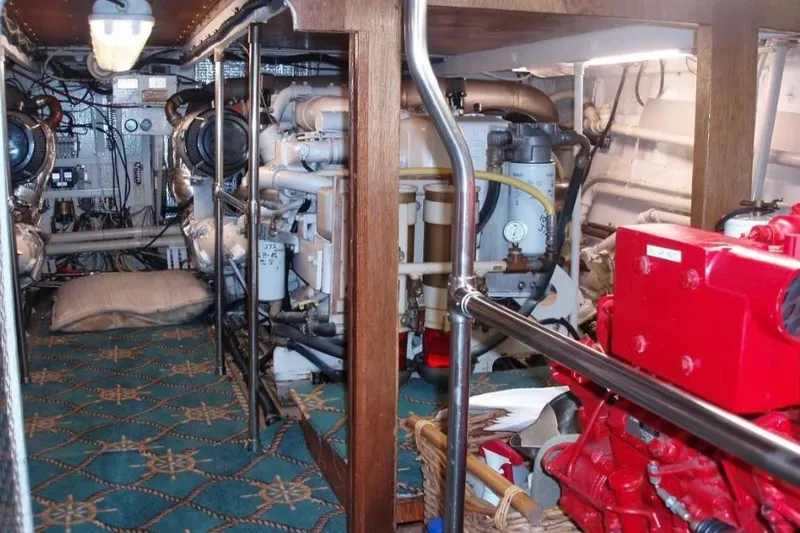 Top Coat Yacht Photos Pics Engine room of a 1974 Pacemaker Cockpit Motoryacht with visible machinery and equipment.
