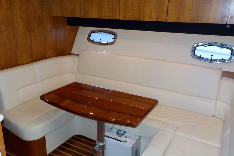 "lady Di" Yacht Photos Pics Luxurious interior of 2009 Tiara Yachts 3900 Open with elegant seating and wooden table.