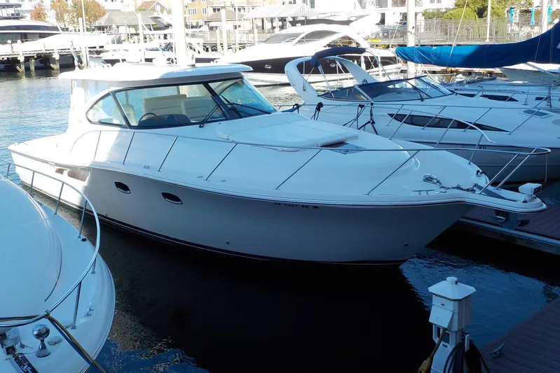 "lady Di" Yacht Photos Pics 2009 Tiara Yachts 3900 Open docked in a marina, surrounded by other boats.