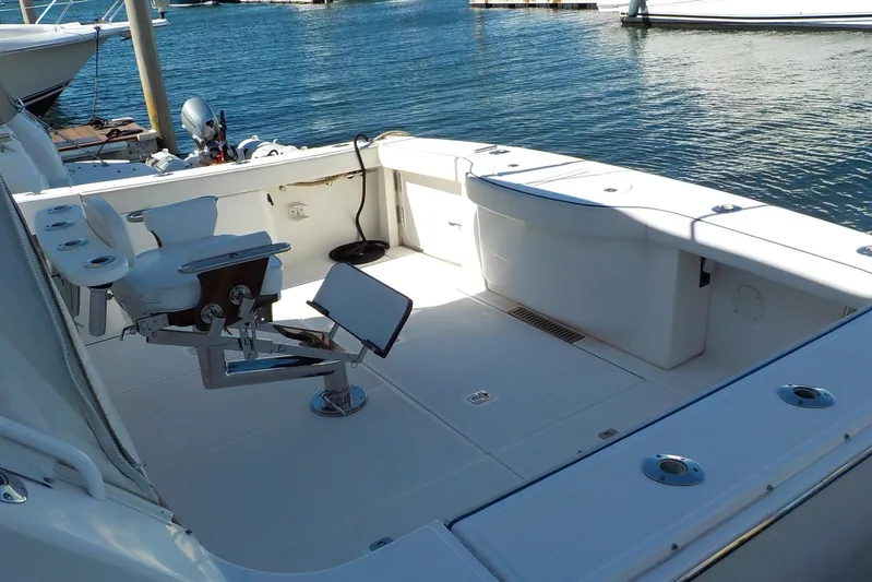 "lady Di" Yacht Photos Pics 2009 Tiara Yachts 3900 Open boat deck with fishing chair, docked by the water.