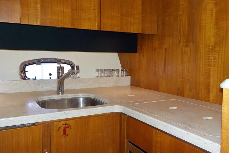 "lady Di" Yacht Photos Pics 2009 Tiara Yachts 3900 Open kitchen with wooden cabinets and stainless steel sink.