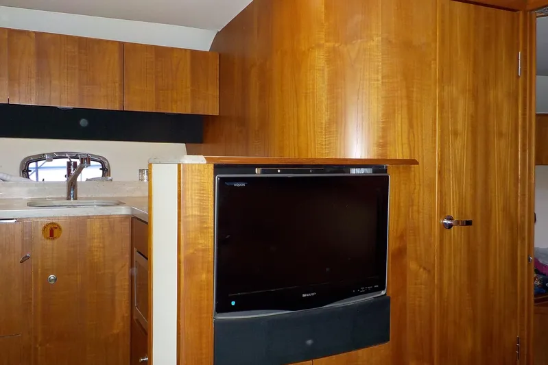 "lady Di" Yacht Photos Pics 2009 Tiara Yachts 3900 Open interior with wood cabinetry and built-in TV.