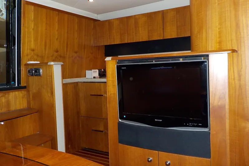 "lady Di" Yacht Photos Pics 2009 Tiara Yachts 3900 Open interior with wood paneling and built-in TV.