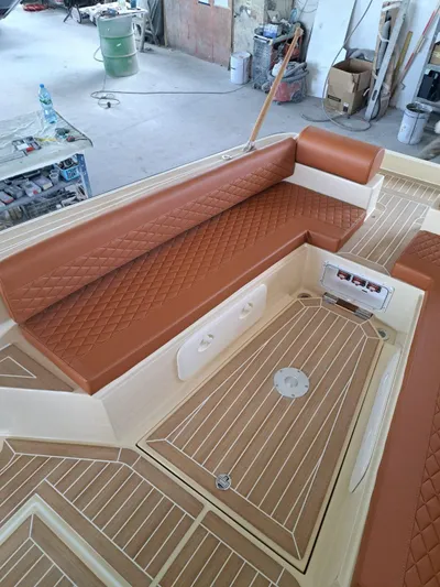  Yacht Photos Pics 2025 Lilybaeum Levanzo 25 Lounge Deck with brown quilted seating and wood-patterned flooring.