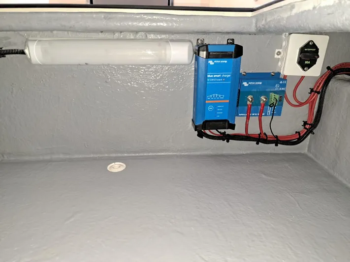  Yacht Photos Pics Electrical setup inside Lilybaeum Levanzo 25 Lounge Deck, featuring a smart charger and wiring.