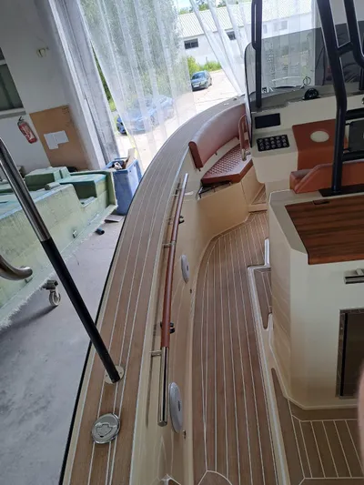  Yacht Photos Pics 2025 Lilybaeum Levanzo 25 Lounge Deck boat interior with wood finish and seating.