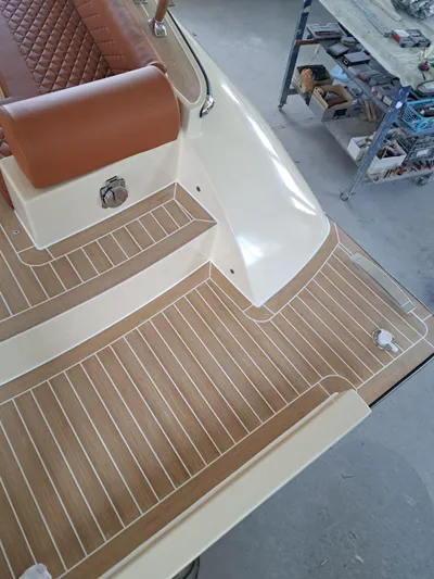  Yacht Photos Pics Luxury deck of 2025 Lilybaeum Levanzo 25 Lounge, featuring elegant wood finish and leather seating.