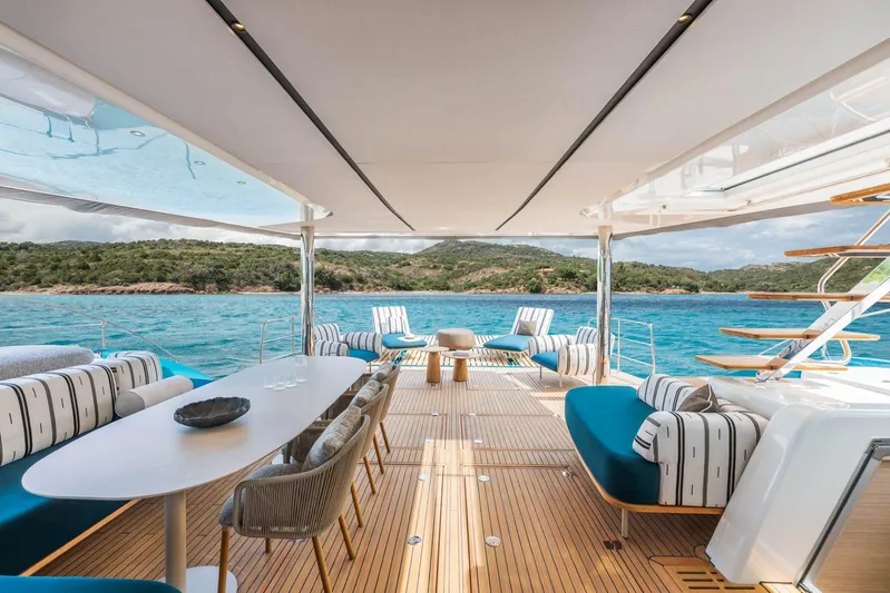  Yacht Photos Pics Manufacturer Provided Image: Luxurious Lagoon Eighty 2 yacht deck with elegant seating, overlooking serene blue waters and lush coastline.