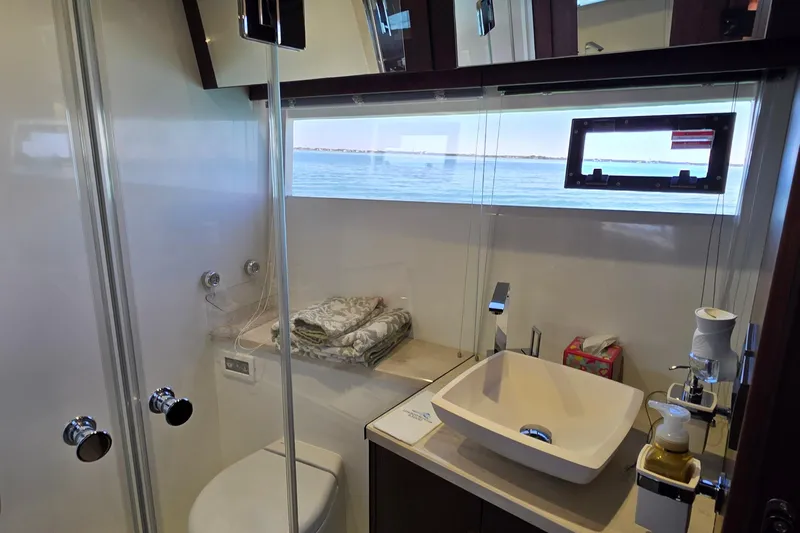 Benellie II Yacht Photos Pics Luxurious bathroom in 2022 Galeon 500 Fly yacht with ocean view window.