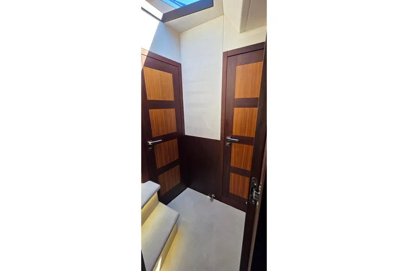 Benellie II Yacht Photos Pics Interior of 2022 Galeon 500 Fly yacht with wooden doors and carpeted stairs.