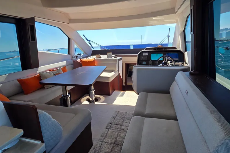 Benellie II Yacht Photos Pics Luxurious interior of 2022 Galeon 500 Fly yacht with modern seating and helm.