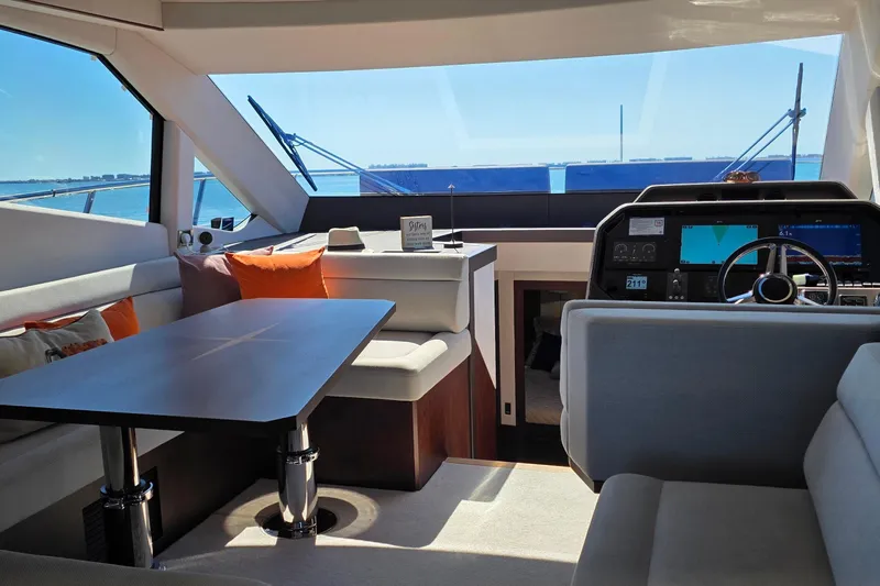 Benellie II Yacht Photos Pics Luxurious interior of 2022 Galeon 500 Fly yacht with modern seating and navigation console.
