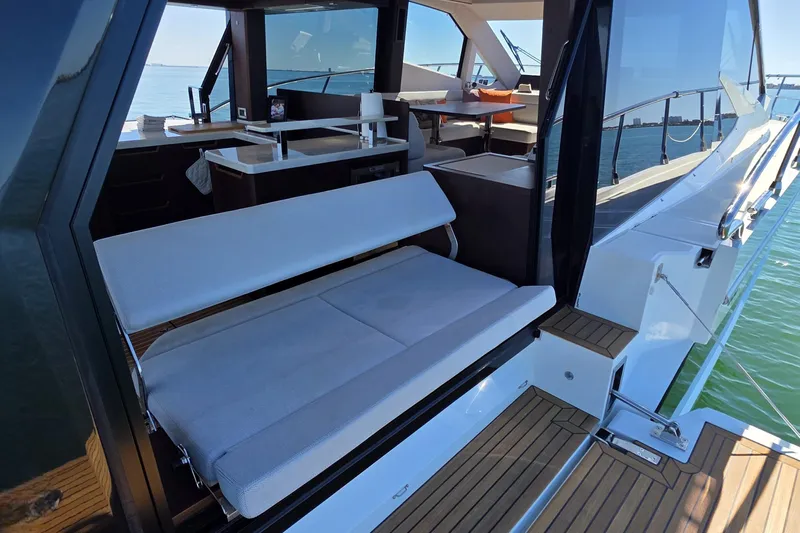 Benellie II Yacht Photos Pics 2022 Galeon 500 Fly yacht interior with seating and dining area, overlooking the ocean.