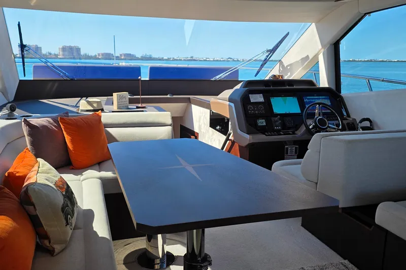 Benellie II Yacht Photos Pics Luxurious interior of 2022 Galeon 500 Fly yacht with modern helm and seating area.