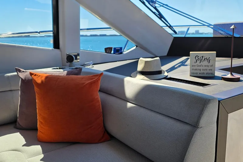 Benellie II Yacht Photos Pics Interior of 2022 Galeon 500 Fly yacht with cushions, hat, and decorative sign.