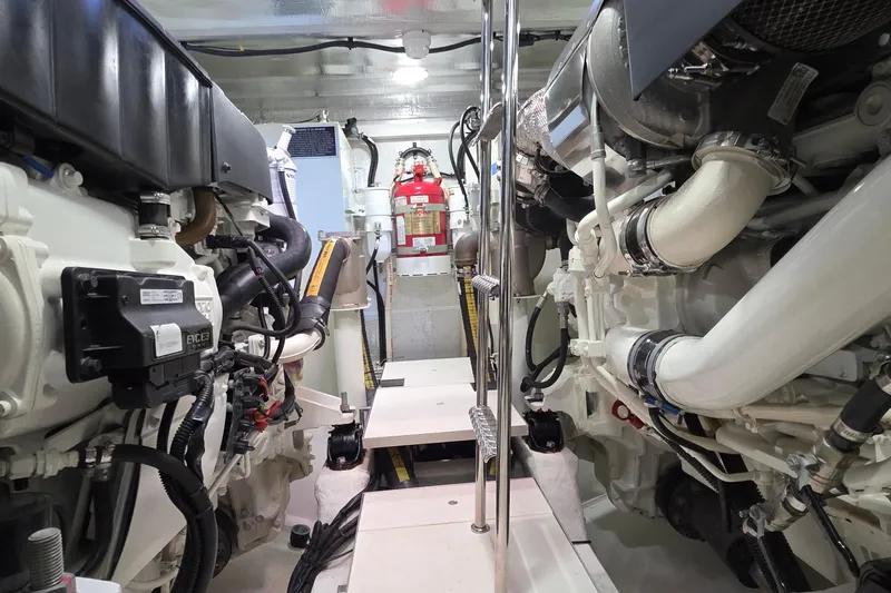 Benellie II Yacht Photos Pics Engine room of 2022 Galeon 500 Fly yacht, showcasing mechanical components and fire extinguisher.