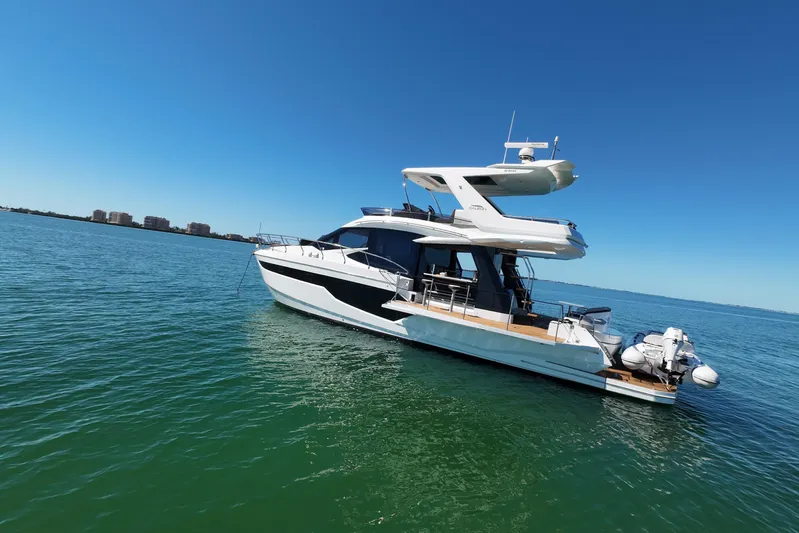 Benellie II Yacht Photos Pics 2022 Galeon 500 Fly yacht on calm blue water under clear sky.