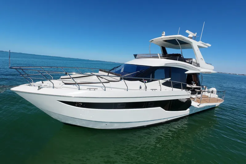 Benellie II Yacht Photos Pics 2022 Galeon 500 Fly yacht on calm blue water under clear sky.