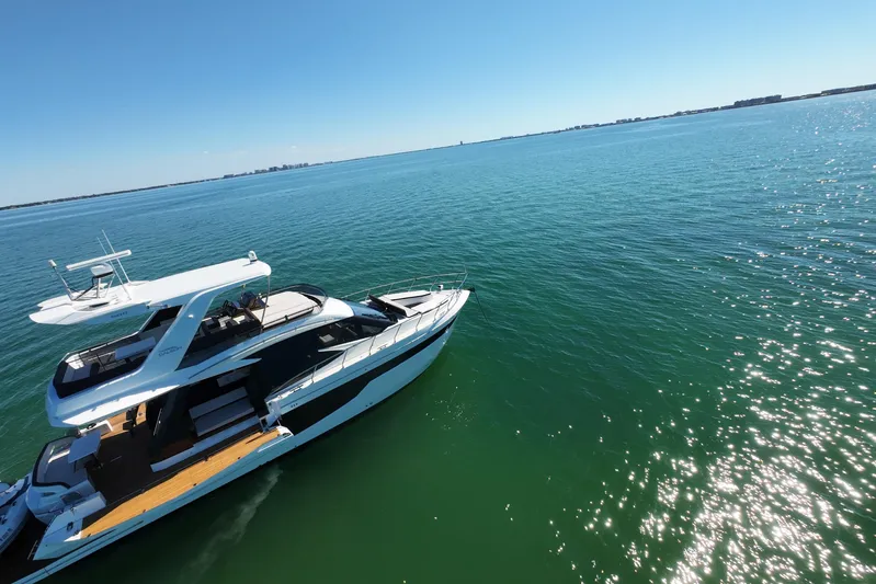 Benellie II Yacht Photos Pics 2022 Galeon 500 Fly yacht cruising on clear blue waters under a sunny sky.