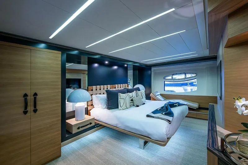 Coal Blooded Yacht Photos Pics Luxurious bedroom interior on a 2014 Pershing 92 yacht, featuring modern design and elegant furnishings.