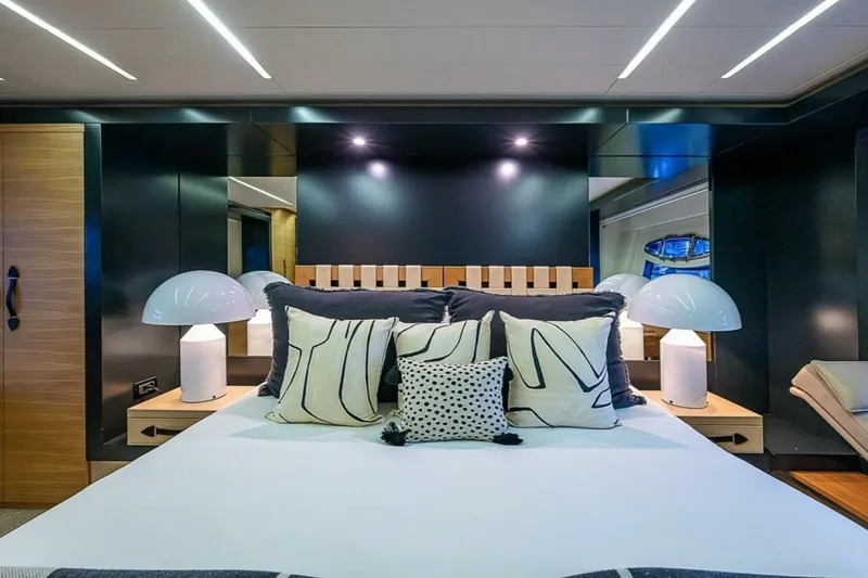 Coal Blooded Yacht Photos Pics Luxurious bedroom interior on a 2014 Pershing 92 yacht with modern decor and ambient lighting.