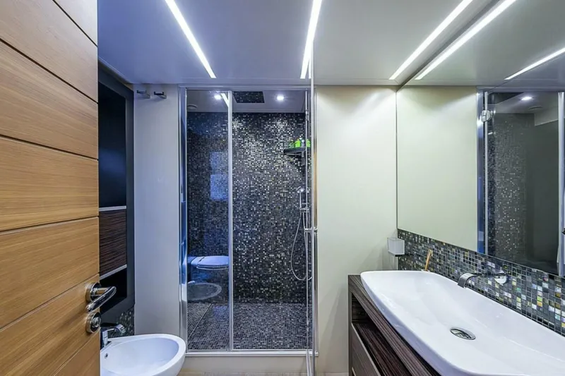 Coal Blooded Yacht Photos Pics Luxurious bathroom on 2014 Pershing 92 yacht with modern fixtures and mosaic tiles.