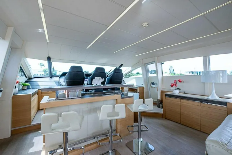 Coal Blooded Yacht Photos Pics Luxurious interior of a 2014 Pershing 92 yacht with modern seating and elegant decor.